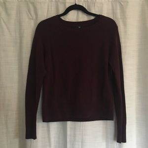 Maroon crew neck sweater.